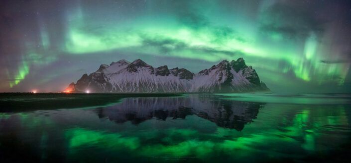 Panorama photo of Northern Lights over Vestrahorn in Iceland. Buy a canvas, framed or acrylic fine art print.