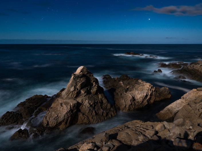 Night photo of rocks at Garrapata National Park in California lit by full moon. Buy a canvas, framed or acrylic fine art print.
