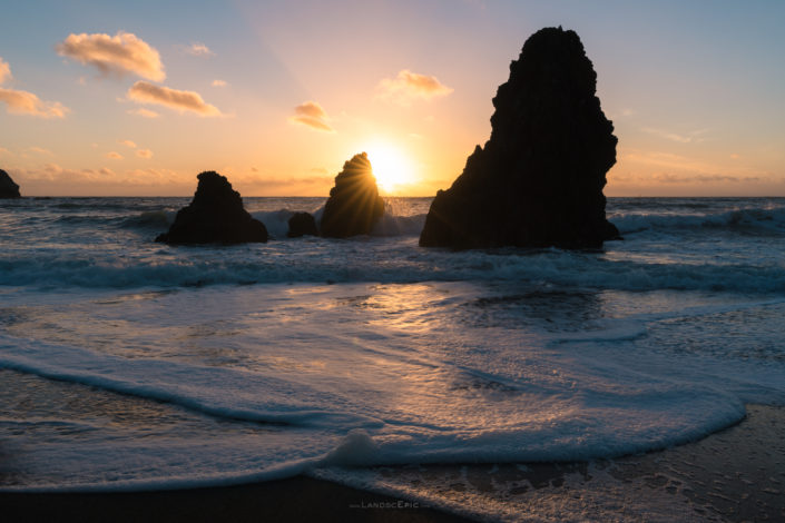 Photo of a sunstar over a rock at Rodeo Beach, California. Buy a canvas, framed or acrylic fine art print.
