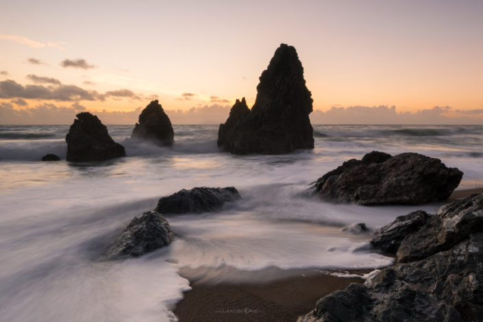 Waves crushing over rocks during sunset at the Rodeo Beach in California, USA. Buy a canvas, framed or acrylic fine art print.