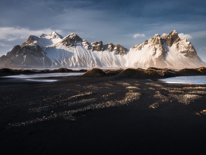 Photo of beautiful stone patterns on the beach of Stokksnes Peninsula in Iceland with a view on Vestrahorn. Buy a canvas, framed or acrylic fine art print.