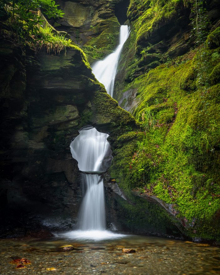 St Nectan's Glen waterfall in England, UK. Buy a canvas, framed or acrylic fine art print.