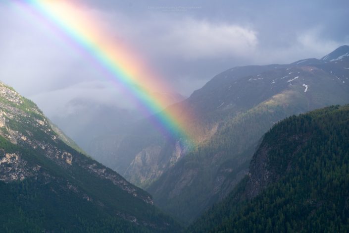 Buy a canvas, framed or acrylic fine art print. Rainbow in Swiss Alps.
