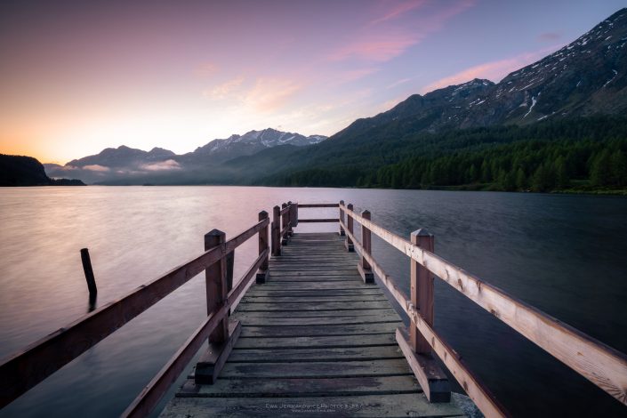 Buy a canvas, framed or acrylic fine art print. Photo of sunrise at Silsersee in Switzerland with a wooden dock.